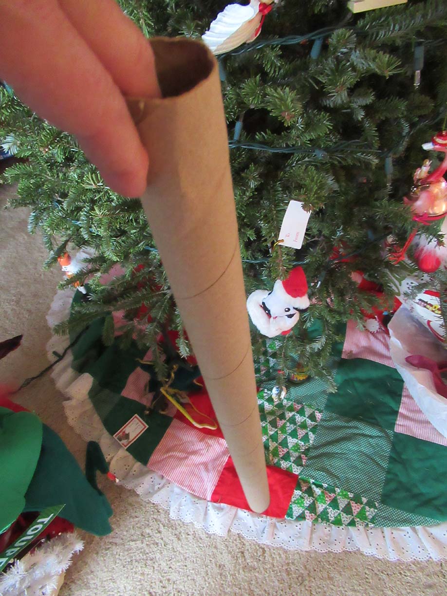 watering christmas tree using an empty wrapping paper roll